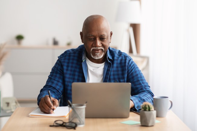 Person reviewing an online loan application and checklist to improve approval odds