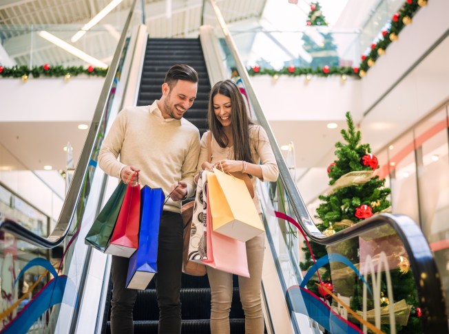 Family planning low-cost holiday gifts at a kitchen table with a budget list.